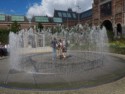 Boys standing within a fountain