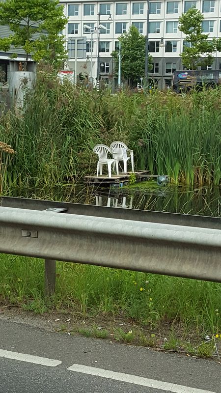 Plastic chairs in a pond