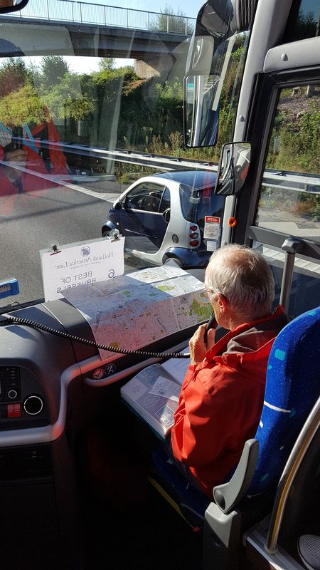 A Smart Car drives past our tour bus