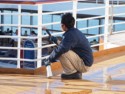 A crew member cleans the railings