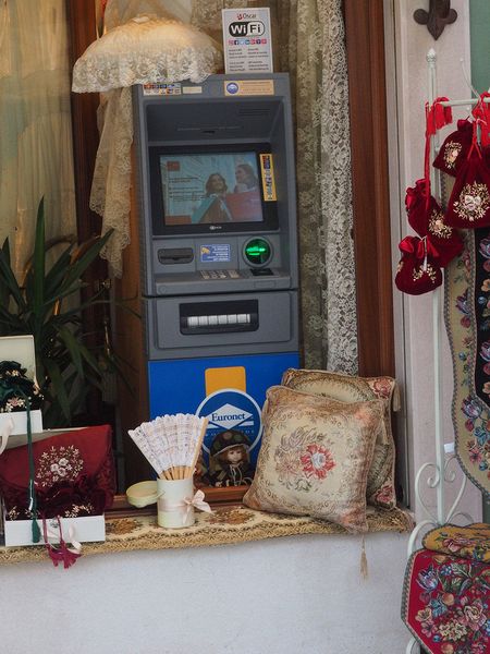 An ATM nestled in a shop window