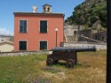 Cannon in front of an old Venetian building