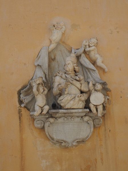 The man and the cherubs look grumpy