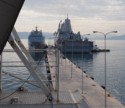 Two US Navy ships are docked at the same pier as us