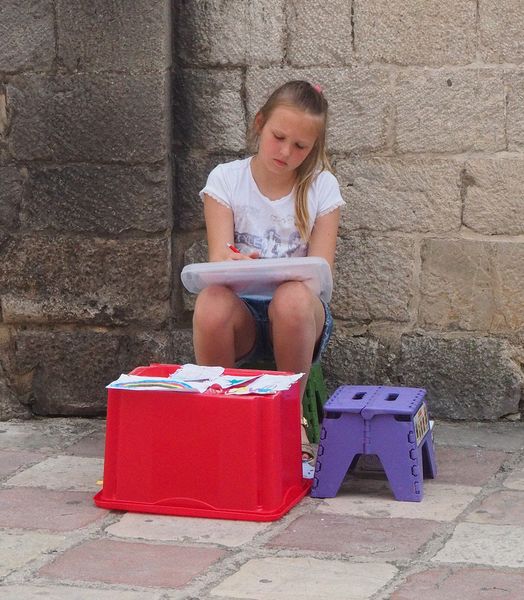 A little girl is drawing pictures