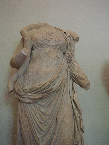 A snake twists around a statue of Hygeia