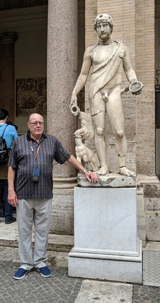 Livingston near a statue of a man with his dog