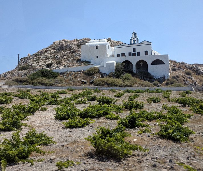 Church on a hillside above grape vines