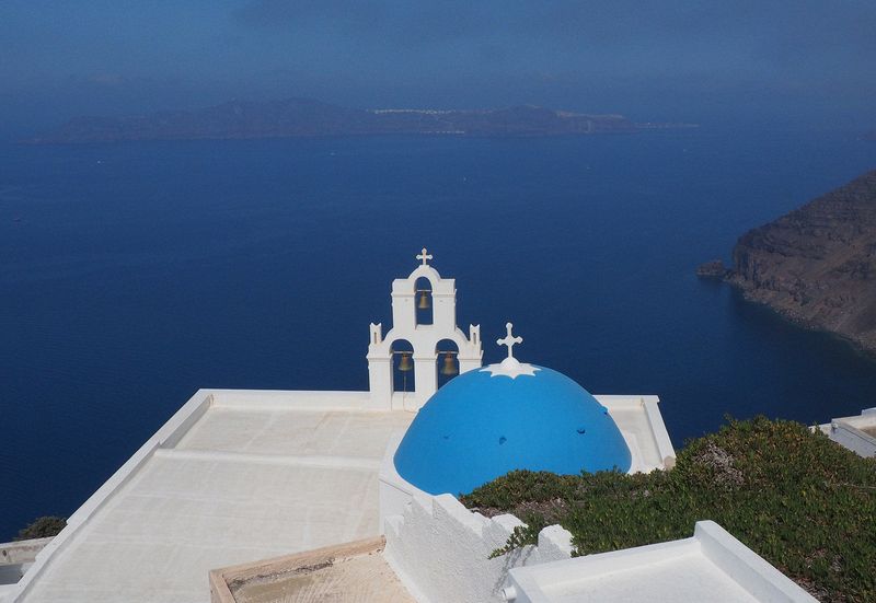 Blue dome and bell tower in Firostefani