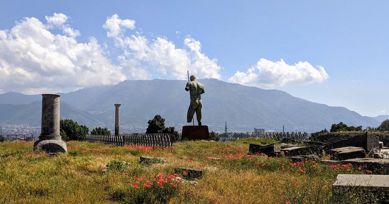 An armless statue overlooks the valley below