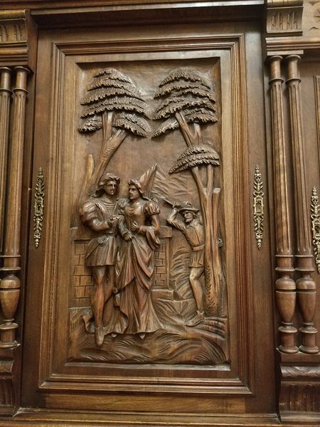 Carved cabinet door showing an assassin