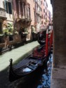 Gondolas next to a wall with flower pots