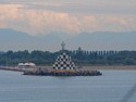 Punta Sabbioni lighthouse with Dolomite Mountains in the background