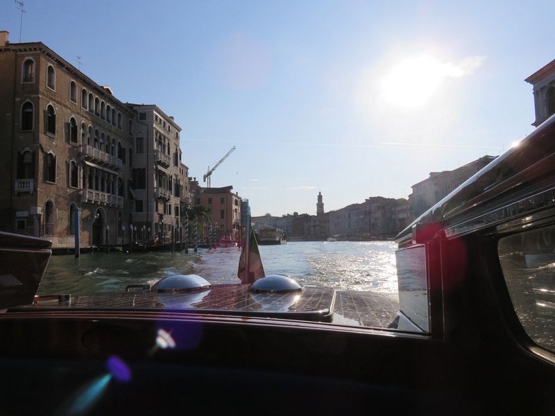 We take a water taxi to a van for the airport