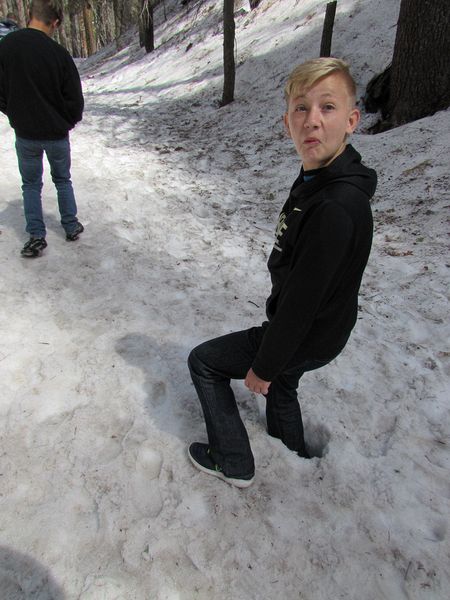 Nicholas's foot sinks into the snow