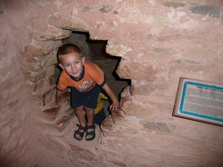 016 Andrew crawling through a cliff dwelling passage