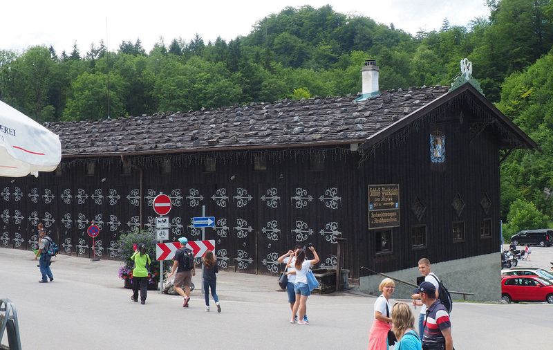 An old barn with rocks on the roof