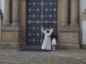 The little girl doesn't seem to be happy with the priest