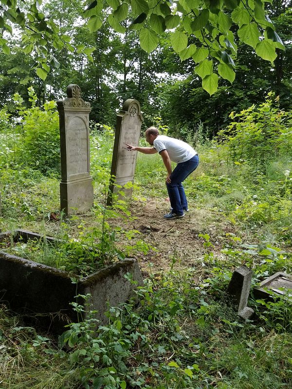 Josh looks at headstones in the old cemetery