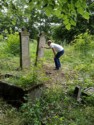 Josh looks at headstones in the old cemetery