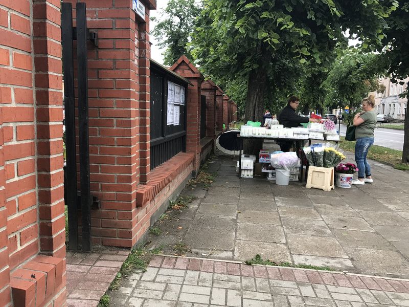 People selling candles and flowers for the graves