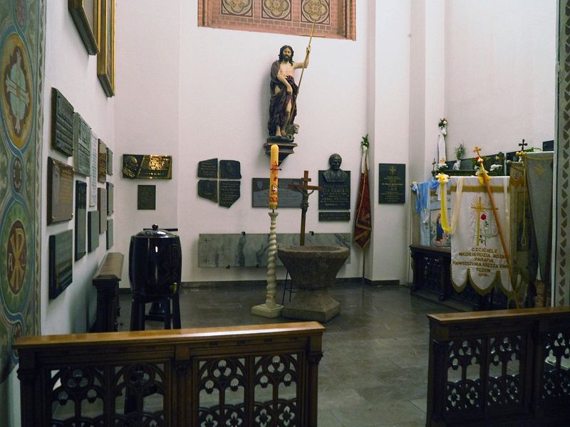 Various memorial plaques on the walls of the baptistry