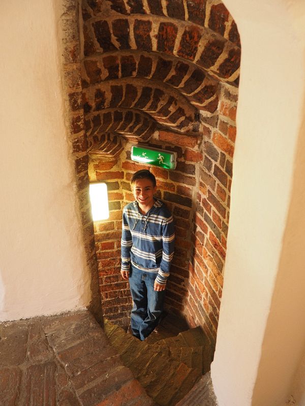 Andrew going down a stone spiral staircase