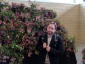 Ehren next to a wall of flowers
