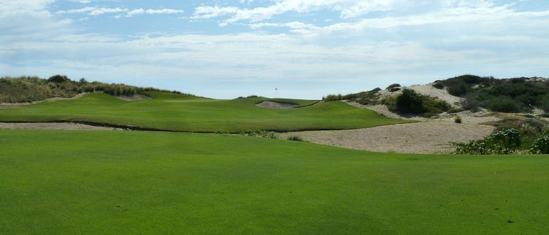 Lots of sand and brush around this green