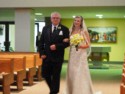 Courtney on her Dad's arm as they walk down the aisle