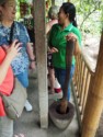 Linda talks to a woman grinding coffee with a mortar and pestle