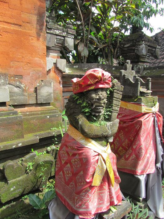 Monkey god holding a club next to offering throne