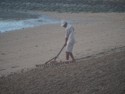 Raking the beach at the hotel