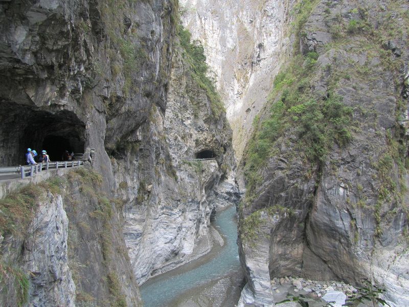 The road weaves through tunnels along the gorge