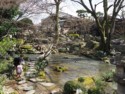 A man walks with his daughter next to the stream