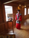 A staff member in kimono advertises a tea ceremony