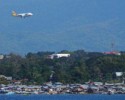 A plane comes in for a landing behind the water village