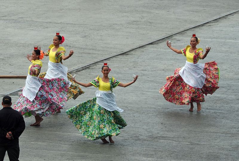 Local dancers balance a glass on their heads