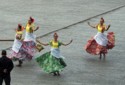 Local dancers balance a glass on their heads