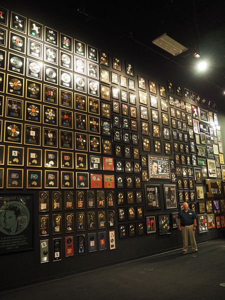 Pete stands next to a massive wall of gold records