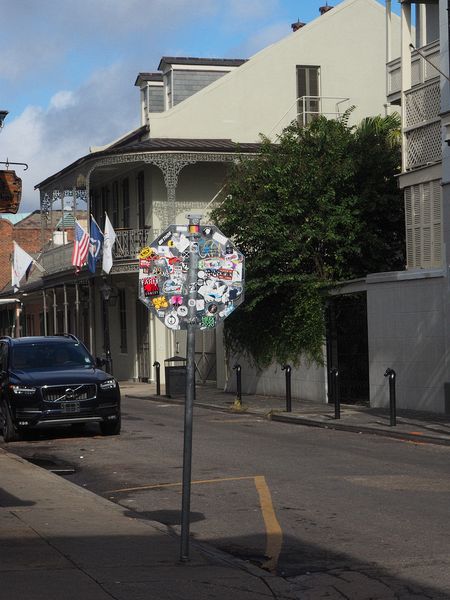 Lots of stickers on the back of a stop sign