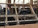 Pete next to a cannon inside the framing for the ironclad riverboat