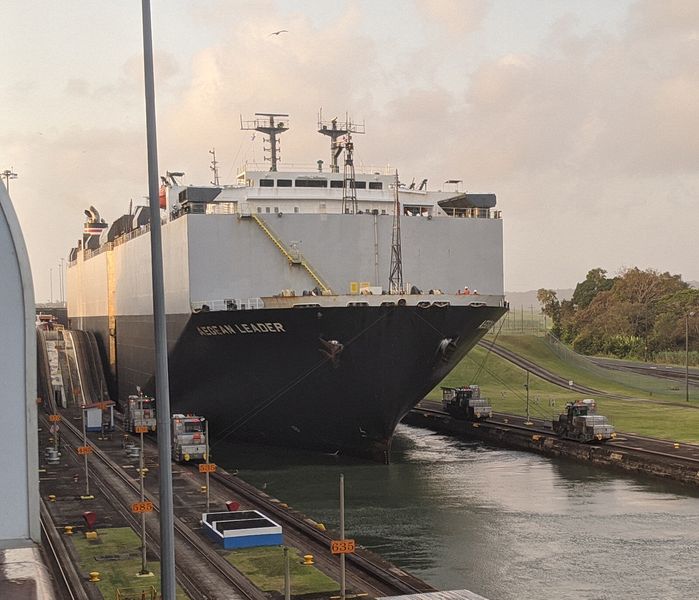 Four locomotives pull the ship next to us as it reaches sea level