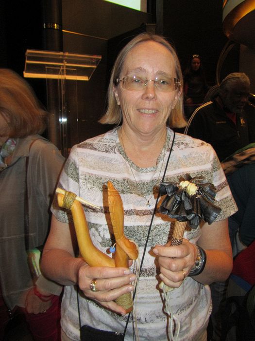 June holds a Tlingit fish hook and artwork