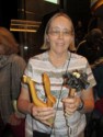 June holds a Tlingit fish hook and artwork