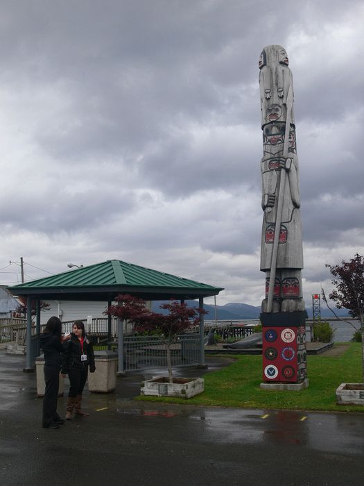 Our local guides next to a totem pole