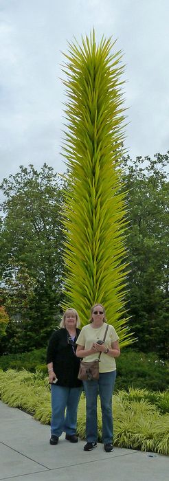 Linda and June in front of a tall sculpture