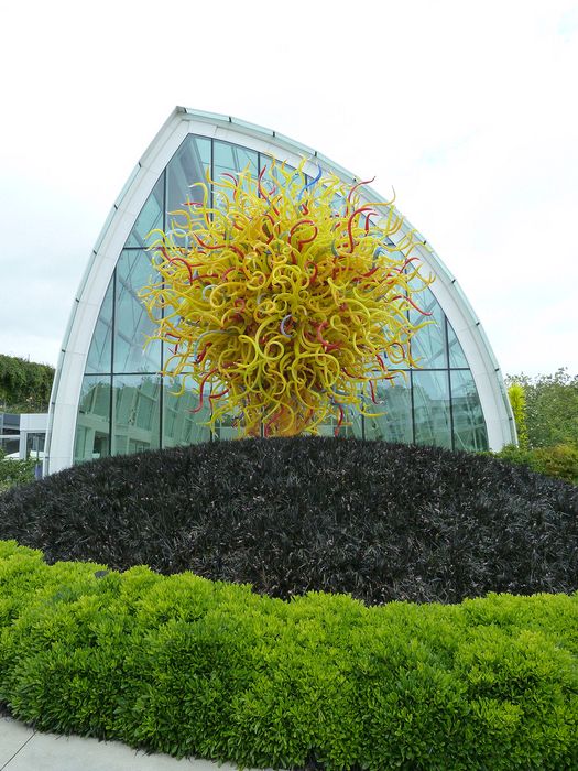 Outdoor sculpture in front of the glass building