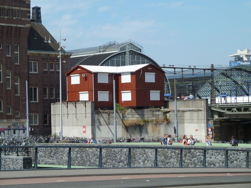 Red building perched by the railway station