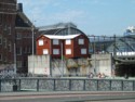 Red building perched by the railway station